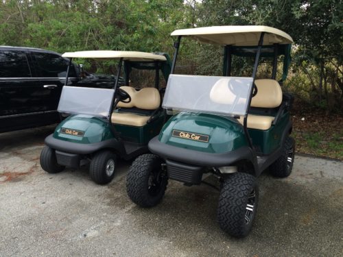 Large and small club car golf carts in the parking lot